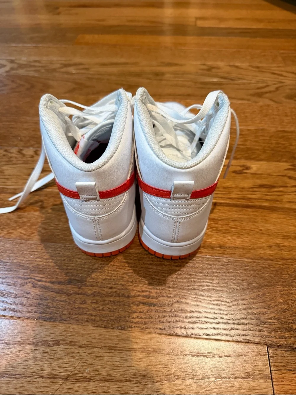 Nike White High-Top Sneakers with Orange-Red Swoosh